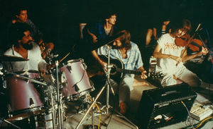 Chuang Tzu Auditorium, Poona, 1983 : Sw Teerth (percussion), Sw Prabodh (bass), Ma Bharti (piano), Nivedano (drums), Sw Anand Milarepa (guitar), violin player unknown