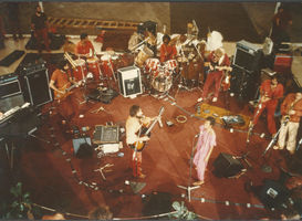 Darshan-Satsang band 1984 : clockwise from left: Sw Prem Geet (bass), Sw Shiven (congas), Nivedano (drums), Sw Govinddas (guitar), Sw Devakant (flutes), Sw Toby (saxophone), Ma Anand Suresha (vocals) & Sw Prem Anubhava (vocals & guitar)